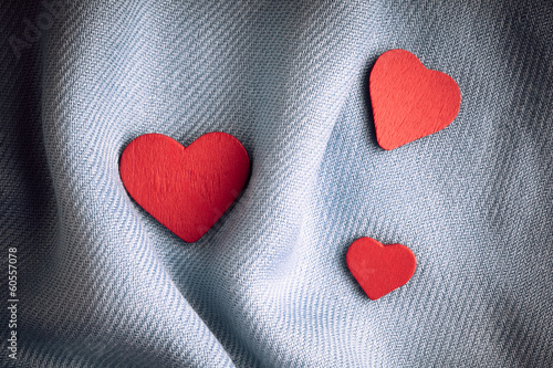Valentine's day background. Red hearts on gray folds cloth