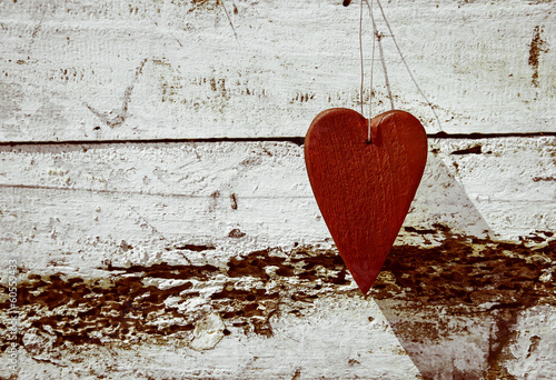 ustic red valentine heart on old weathered wood background. photo