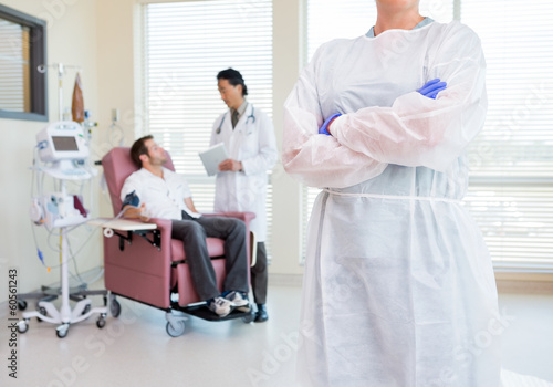Nurse Standing Arms Crossed While Doctor Examining Patient s Hea