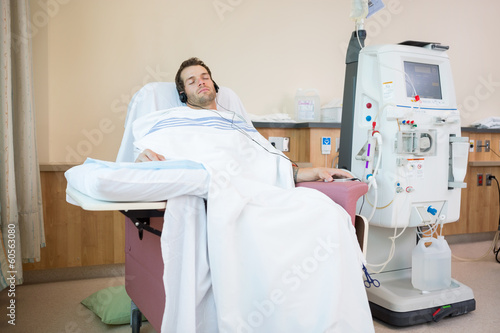 Patient Sleeping While Listening Music at Dialysis Center photo