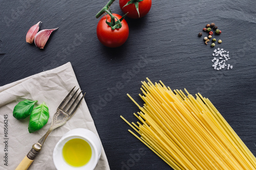 Pasta ingredients on black slate background
