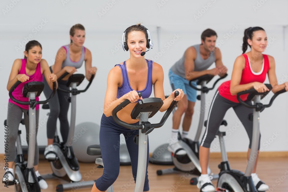 Fit people working out at spinning class Fit people working out at spinning class