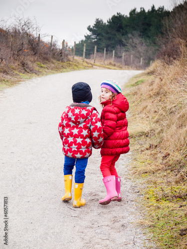 small boy and girl walking hand in hand