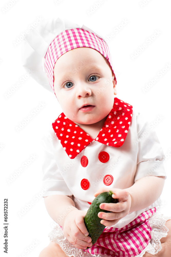 Baby cook girl wearing chef hat with fresh vegetables Baby cook girl wearing chef hat with fresh vegetables