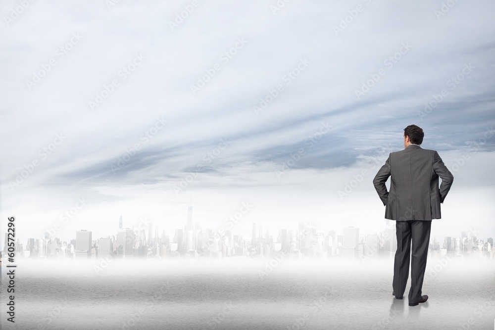 Composite image of businessman with hands on hips Composite image of businessman with hands on hips
