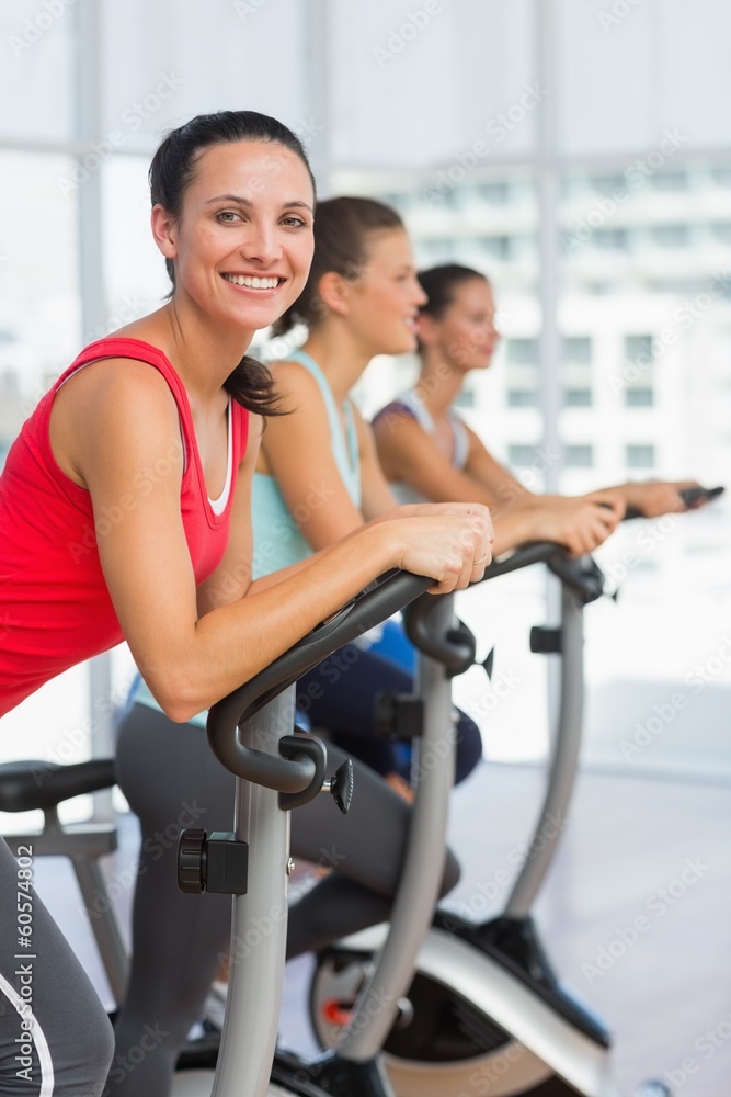 Fit young people working out at spinning class Fit young people working out at spinning class
