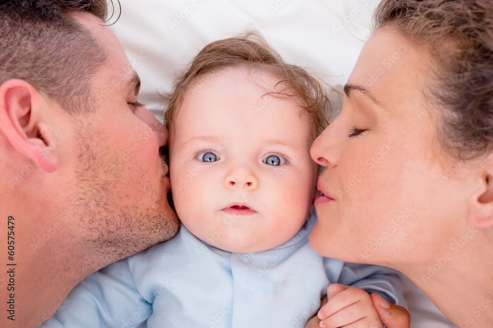 Loving parents kissing baby Loving parents kissing baby