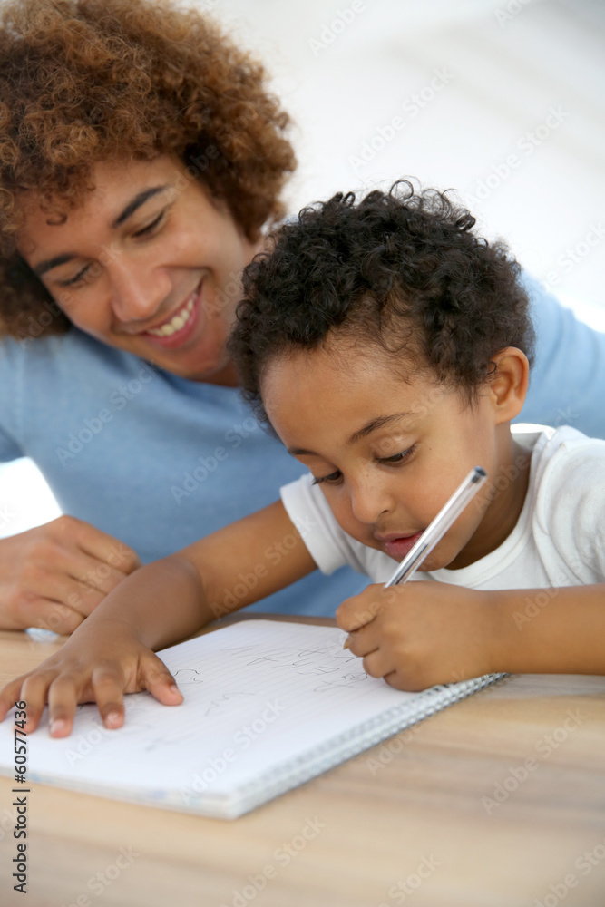 Daddy and son drawing on notebook at home Daddy and son drawing on notebook at home