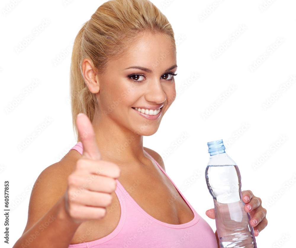 Attractive young woman holding bottle of water and holding thumb Attractive young woman holding bottle of water and holding thumb
