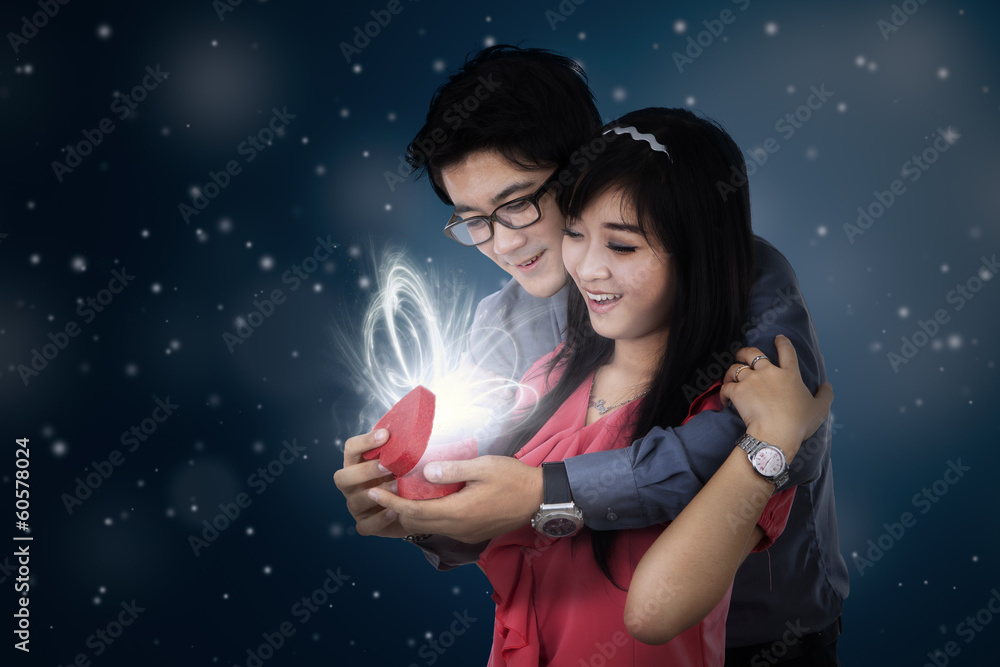 A man giving a present to his wife A man giving a present to his wife