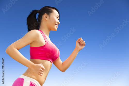 Fototapeta Naklejka Na Ścianę i Meble -  Runner woman jogging in sunny day