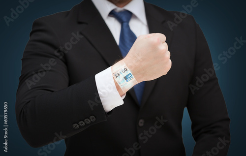 businessman showing something at his hand