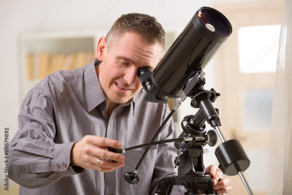 Man looking through telescope Man looking through telescope
