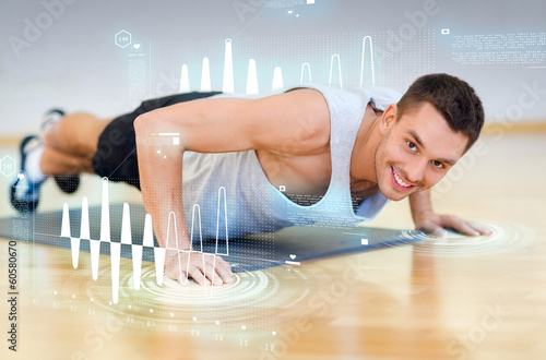 smiling man doing push-ups in the gym