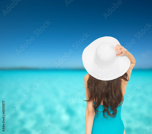 model in swimsuit with hat