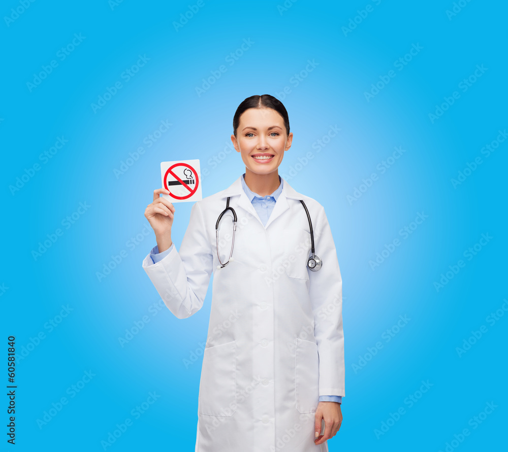 smiling female doctor holding no smoking sign smiling female doctor holding no smoking sign