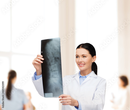 smiling female doctor looking at x-ray