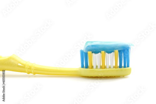 Tooth brush with toothpaste over white background