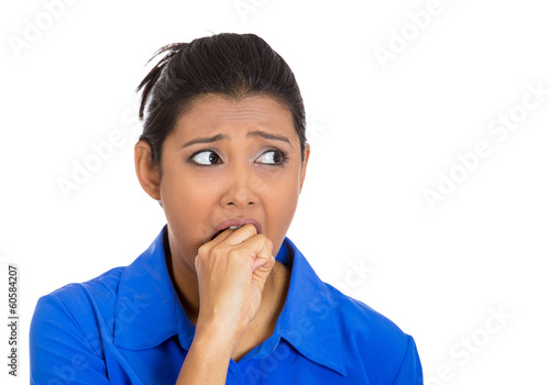 Obsessive woman biting her hand, looking to side anxiously