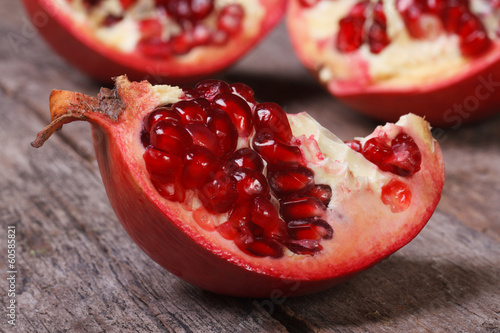 ripe pomegranate on an old wooden table closeup. macro