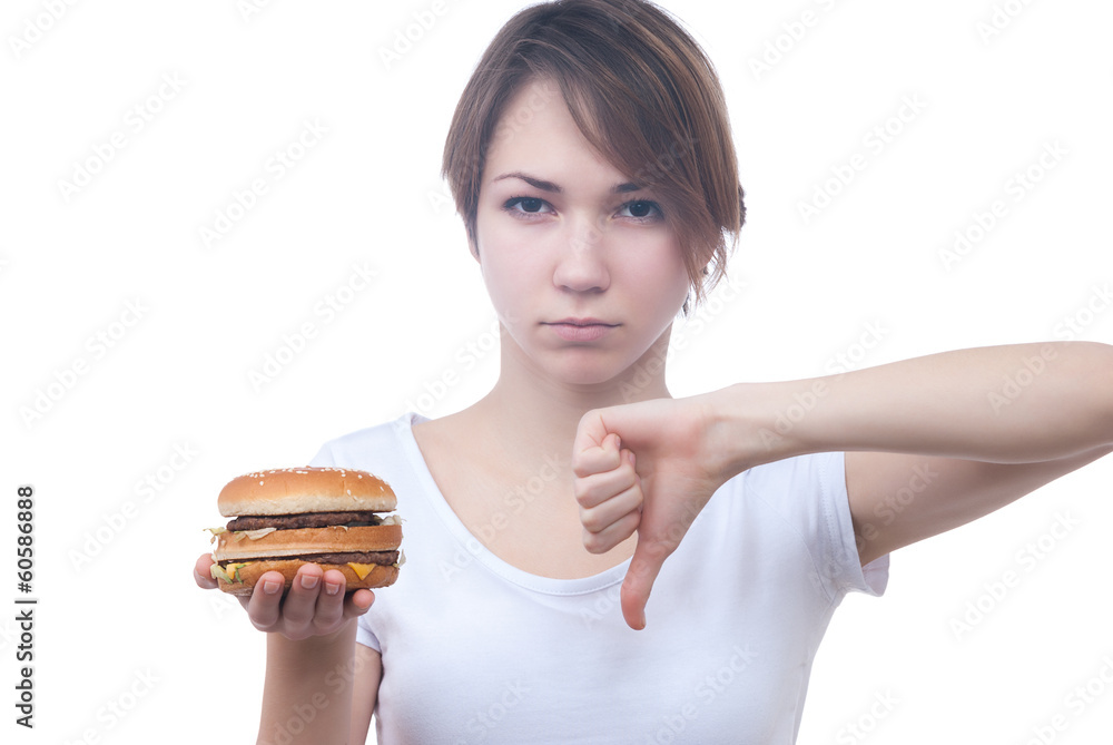 Portrait of girl with humburger showing thumb down Portrait of girl with humburger showing thumb down