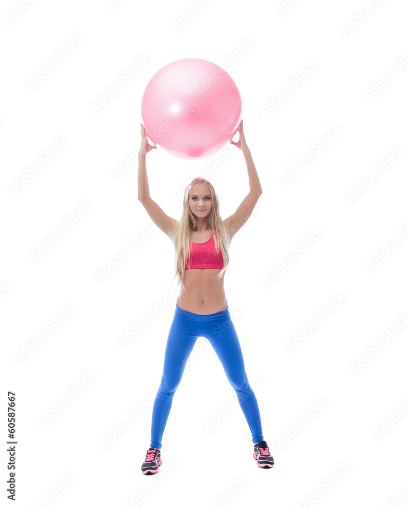 Pretty long-haired sporty model posing with ball