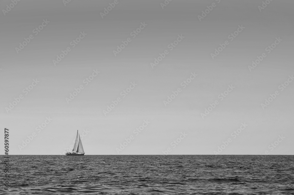 Sailboat alone at open sea black and white