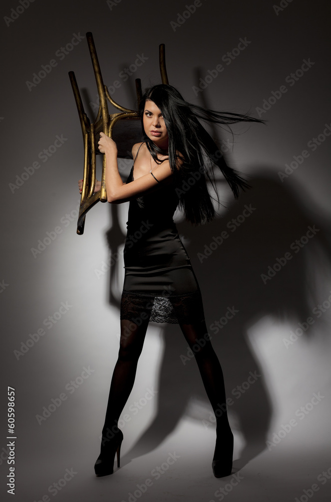 Brunette protected through the use of a chair. Brunette protected through the use of a chair.