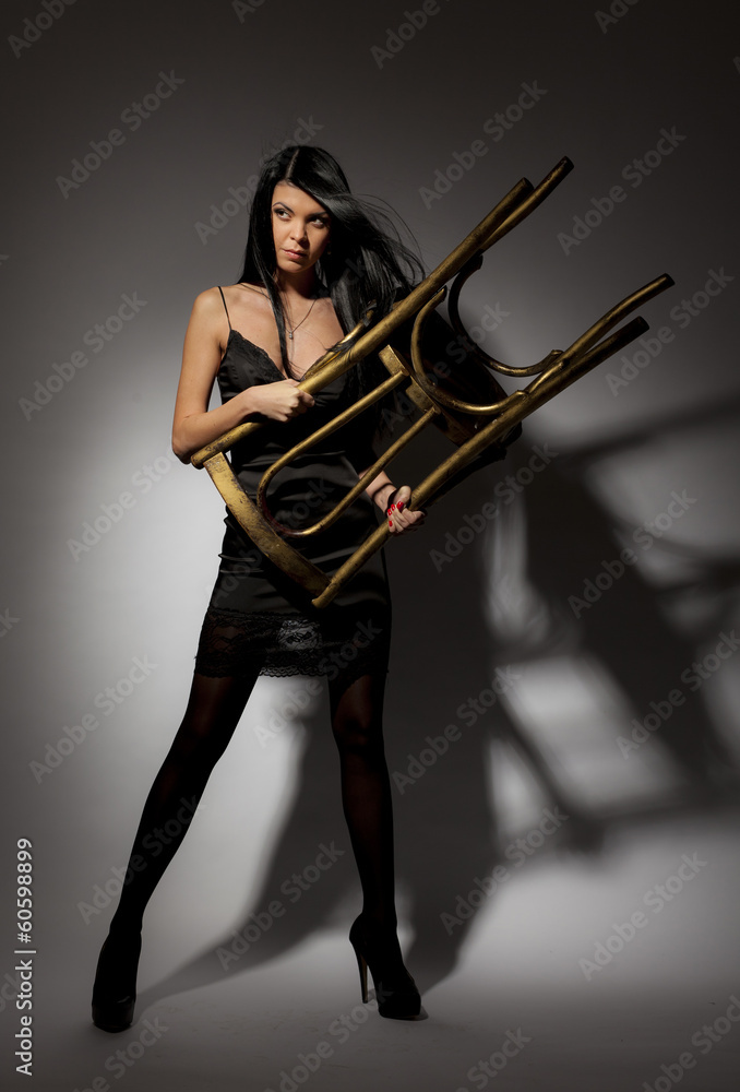 Brunette protected through the use of a chair. Brunette protected through the use of a chair.