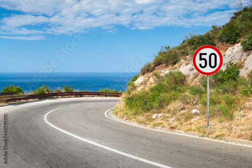 Round speed limit road sign isolated on white
