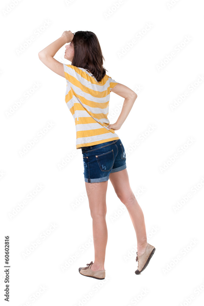 back view of standing young beautiful brunette woman in yellow back view of standing young beautiful brunette woman in yellow