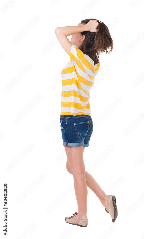 back view of standing young beautiful brunette woman in yellow back view of standing young beautiful brunette woman in yellow