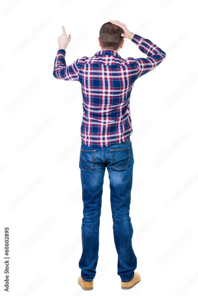 Back view of angry young man in jeans and checkered shirt Back view of angry young man in jeans and checkered shirt