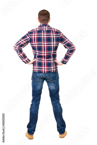 Back view of handsome man in checkered shirt looking up.