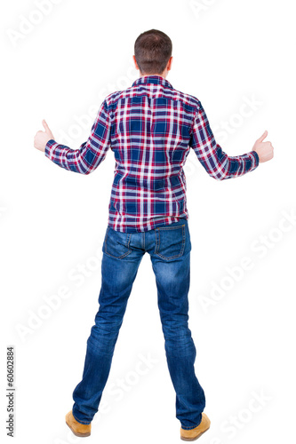 Back view of man in checkered shirt shows thumbs up.