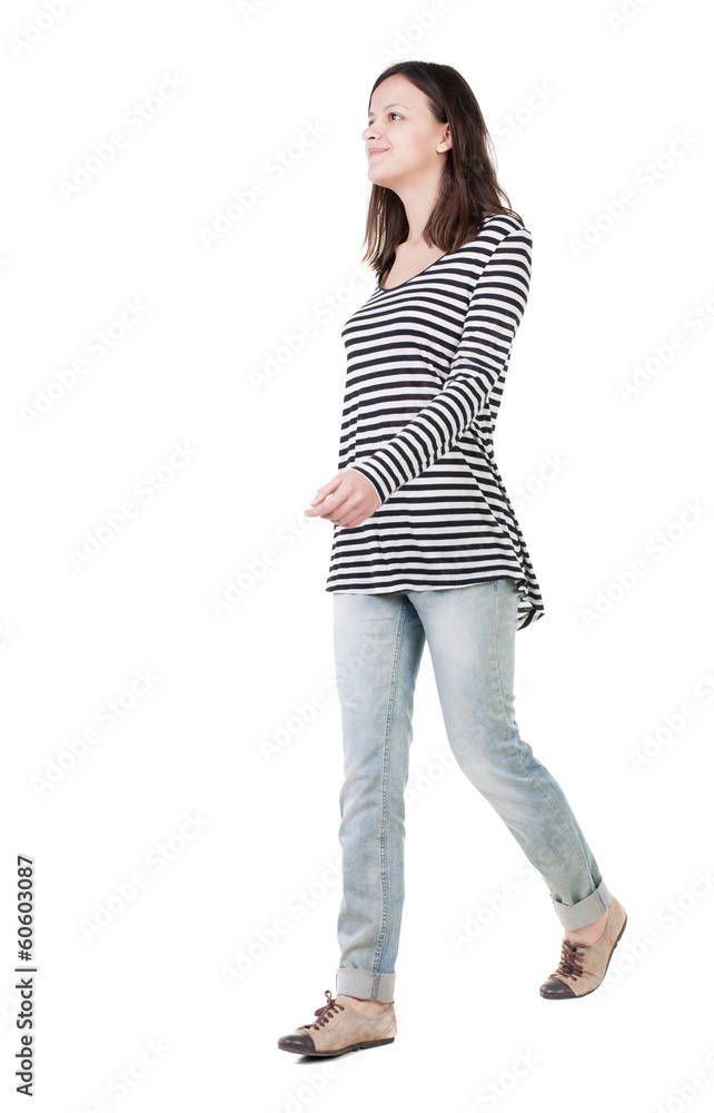 back view of walking woman in jeans . back view of walking woman in jeans .