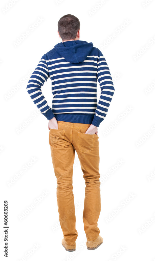 Fototapeta premium Back view of handsome man in striped hooded sweater.