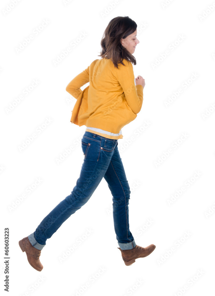 back view of running woman in yellow cardigan back view of running woman in yellow cardigan