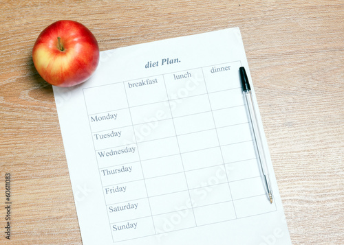 diet Plan. diet plan, pencil and apple lying on a wooden surface