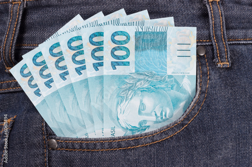Brazilian money in a front pocket of jeans pants photo
