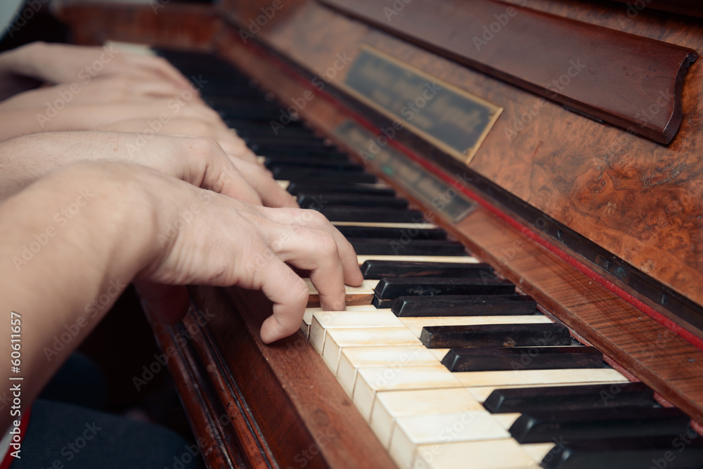 Family of three people is playing the piano