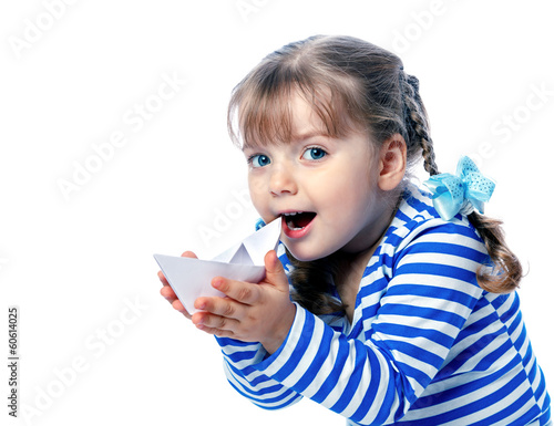 portrait of a little girl holding a paper boat on a white backgr