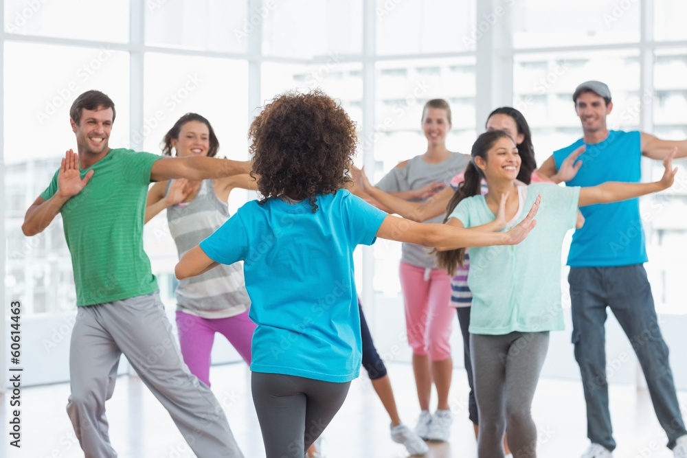 Fitness class and instructor doing pilates exercise Fitness class and instructor doing pilates exercise