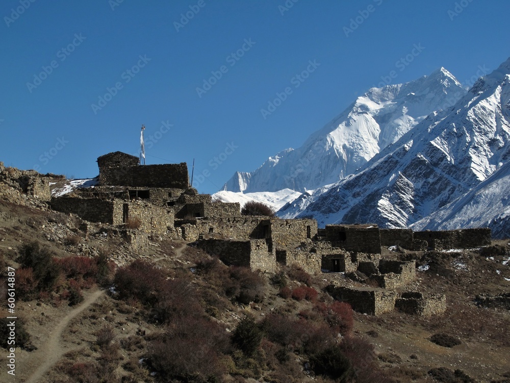 Fototapeta premium Old ruined village and Annapurna Two, Nepal