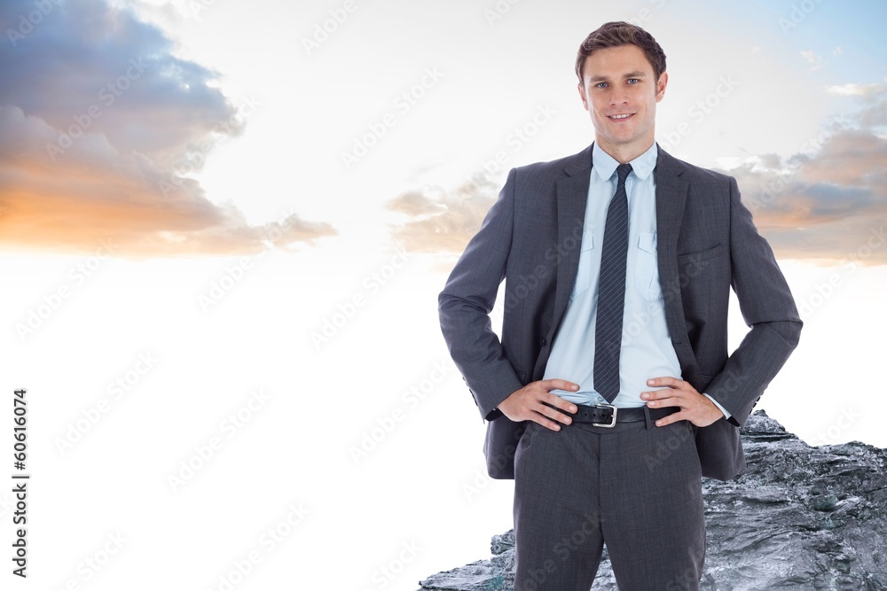 Composite image of smiling businessman with hands on hips Composite image of smiling businessman with hands on hips