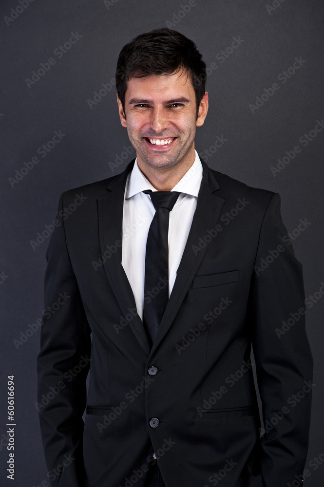 businessman standing on dark background with big smile businessman standing on dark background with big smile