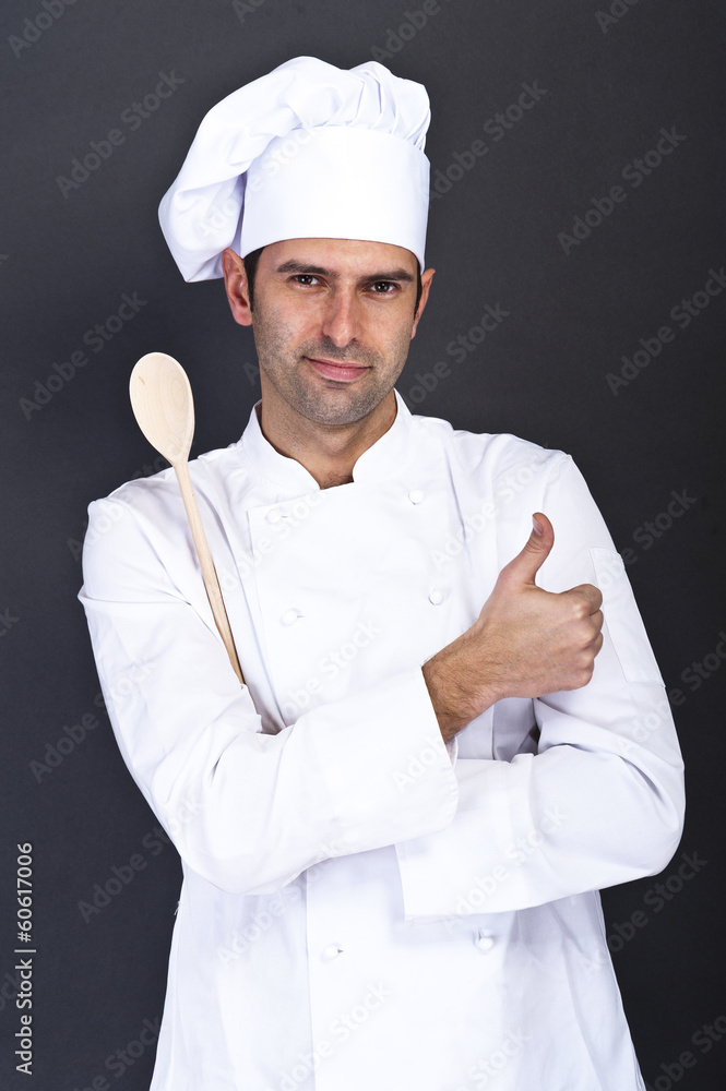 portriat of the cook with spoon over dark background portriat of the cook with spoon over dark background