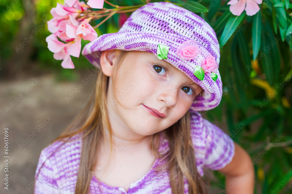 Portrait of a cute little girl in a knitted violet hat Portrait of a cute little girl in a knitted violet hat