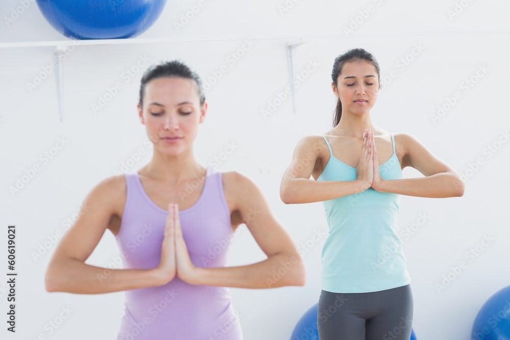 Sporty women with joined hands in fitness studio Sporty women with joined hands in fitness studio