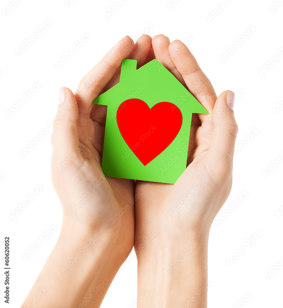 hands holding green paper house hands holding green paper house